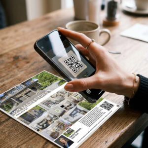 A Hand scanning a QR Code on a Real Estate Brochure